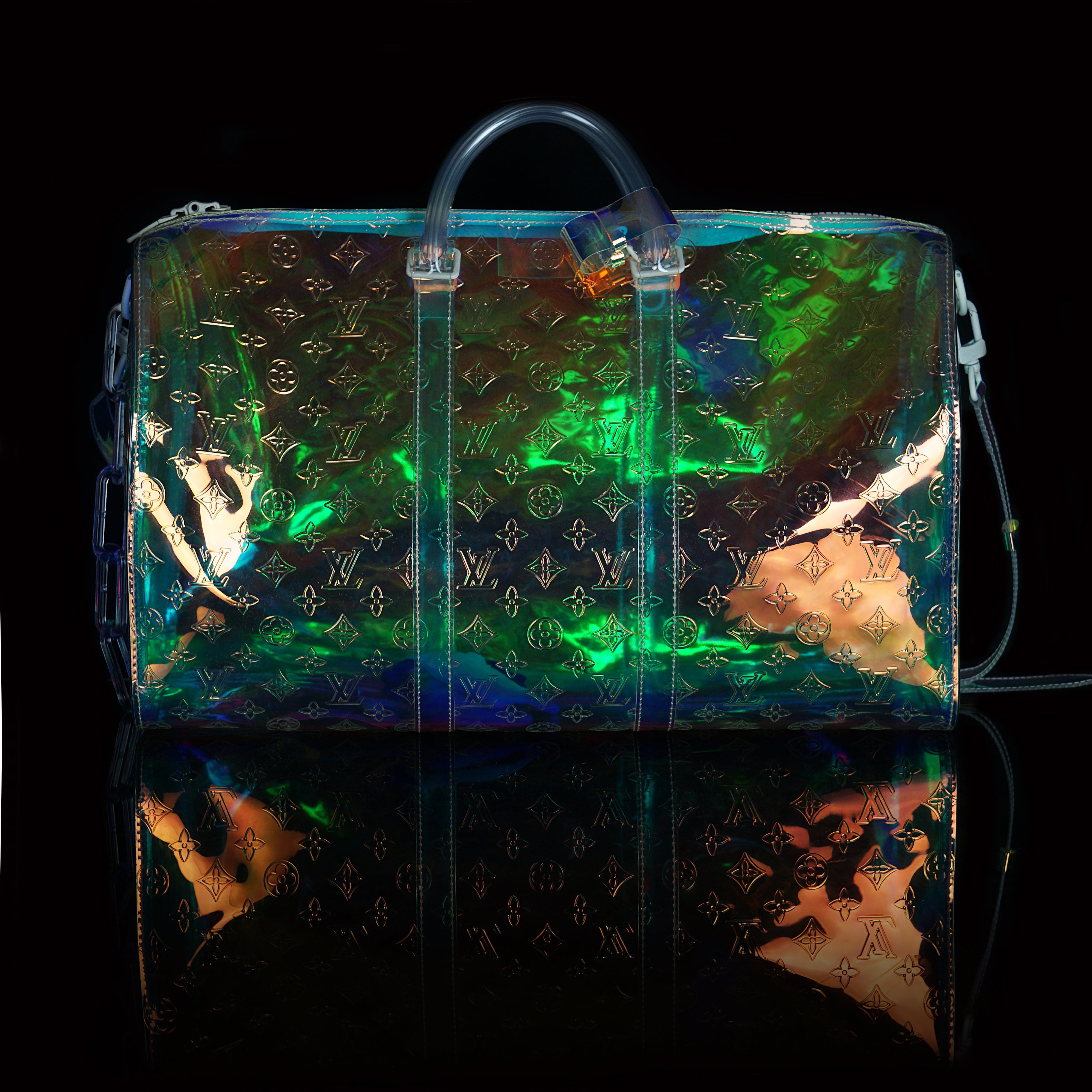 Louis Vuitton-Keepall-L 50 x H 22 x W 29 cm/L 19.7 x H 8.7 x W 11.4 inches Iridescent Prism Transparent embossed Monogram PVC PVC trim White detailing Top handle for hand or elbow carry Leather handle fastener Double zip closure Leather-covered padlock or